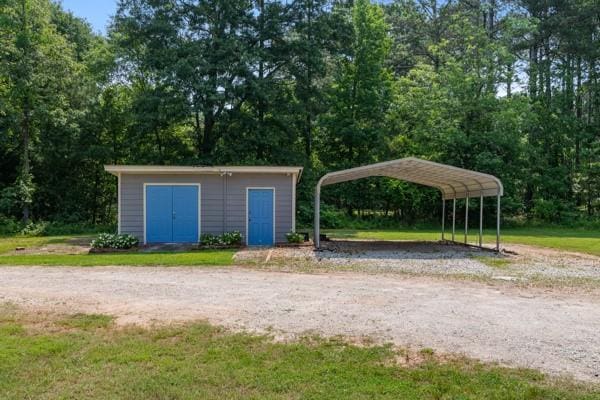 4841 Partee Trl, Social Circle, GA 30025 - view of home's community featuring a detached carport, driveway, and a yard