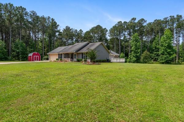 4841 Partee Trl, Social Circle, GA 30025 - view of front facade featuring a storage unit and a front yard