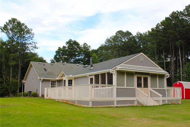 4841 Partee Trl, Social Circle, GA 30025 - back of property featuring a lawn, a sunroom, a wooden deck, and a storage unit