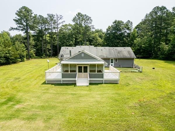 4841 Partee Trl, Social Circle, GA 30025 - rear view of house featuring a deck, a lawn, and a sunroom