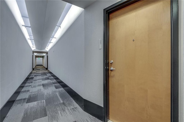 corridor with dark colored carpet