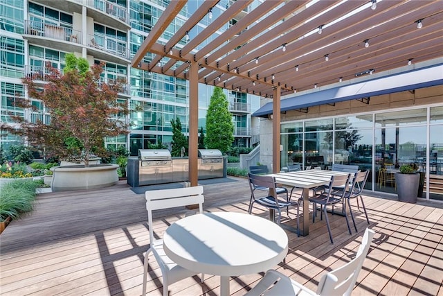 wooden terrace featuring outdoor dining space, a grill, area for grilling, and a pergola