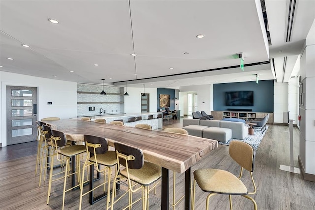 dining space featuring wood finished floors and recessed lighting