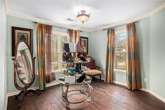 sitting room with hardwood / wood-style floors, visible vents, baseboards, and ornamental molding