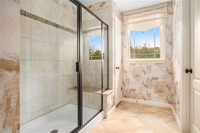 bathroom with baseboards and a stall shower