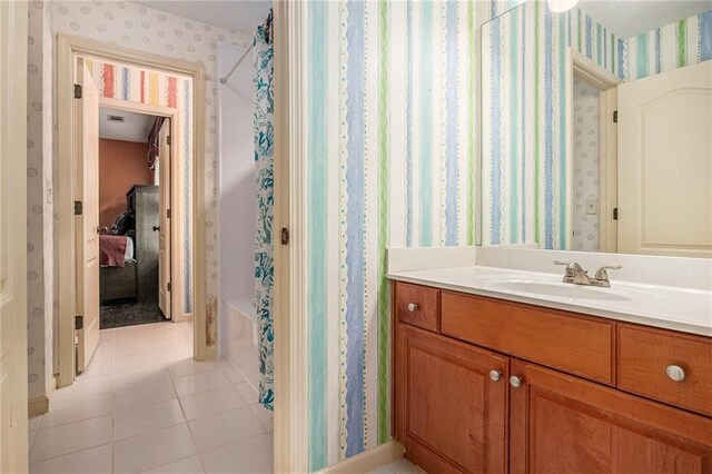 full bathroom featuring tile patterned floors, vanity, and wallpapered walls