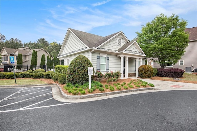 view of front of home featuring fence and uncovered parking