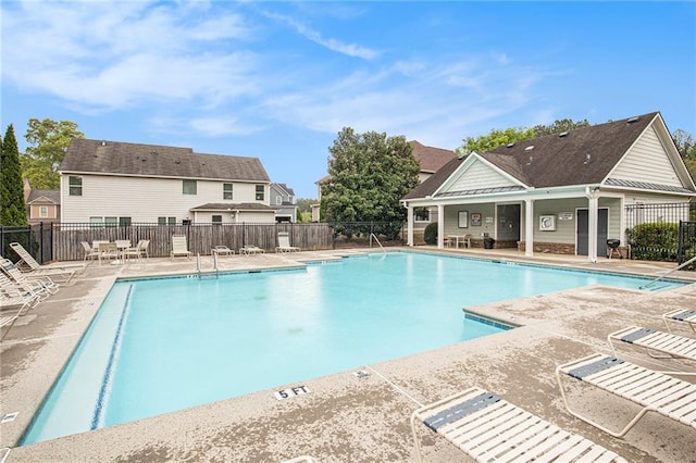 pool featuring fence and a patio