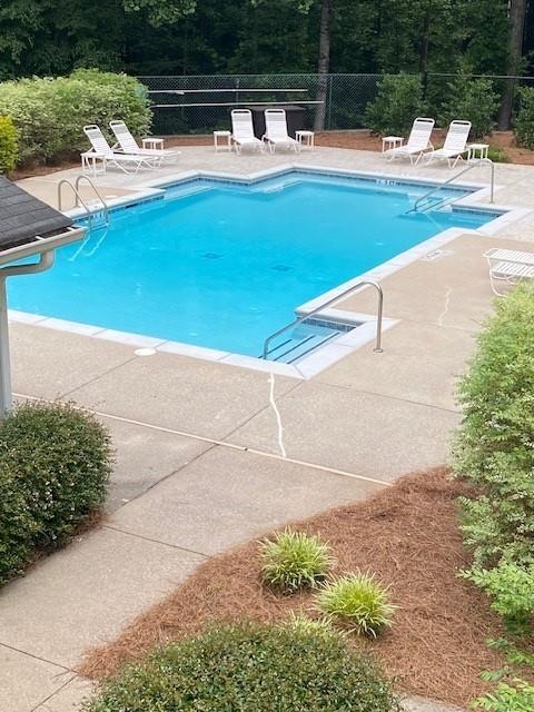 124 Streamside Dr Unit 24, Roswell, GA 30076 - community pool with a patio area and view of wooded area