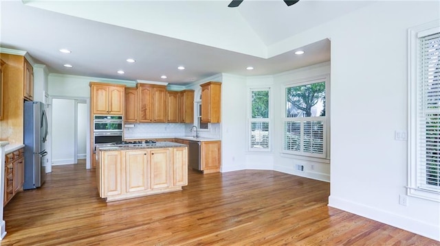 127 Grandmar Chase, Canton, GA 30115 - kitchen featuring appliances with stainless steel finishes, a center island, tasteful backsplash, light wood finished floors, and recessed lighting