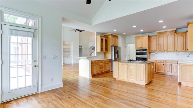 127 Grandmar Chase, Canton, GA 30115 - kitchen with a ceiling fan, appliances with stainless steel finishes, light brown cabinets, light wood-style flooring, and lofted ceiling