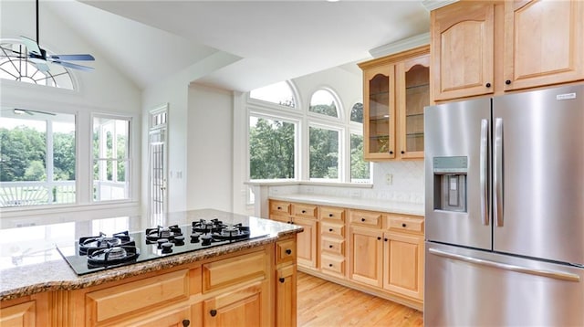 127 Grandmar Chase, Canton, GA 30115 - kitchen with stainless steel refrigerator with ice dispenser, light brown cabinetry, black gas stovetop, ceiling fan, and vaulted ceiling