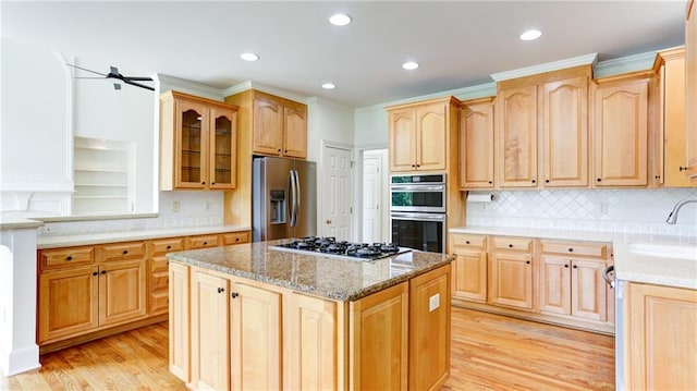 127 Grandmar Chase, Canton, GA 30115 - kitchen featuring appliances with stainless steel finishes, light wood-style floors, glass insert cabinets, a center island, and a ceiling fan