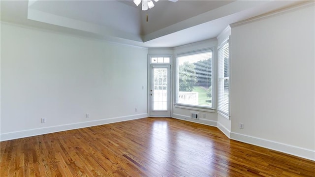 127 Grandmar Chase, Canton, GA 30115 - unfurnished room with wood finished floors, a tray ceiling, a ceiling fan, and ornamental molding