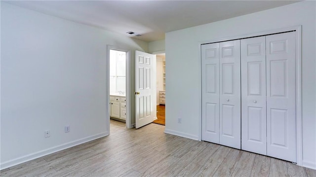 127 Grandmar Chase, Canton, GA 30115 - unfurnished bedroom featuring light wood-type flooring and a closet