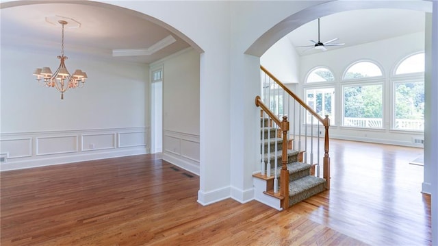 127 Grandmar Chase, Canton, GA 30115 - stairway featuring wood finished floors, ceiling fan, a chandelier, arched walkways, and crown molding