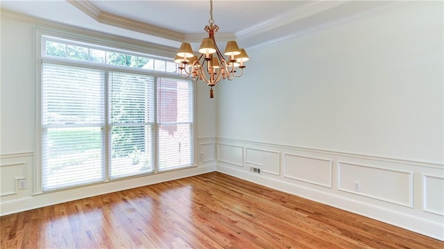 127 Grandmar Chase, Canton, GA 30115 - empty room featuring a chandelier, light wood-type flooring, crown molding, a wainscoted wall, and a decorative wall