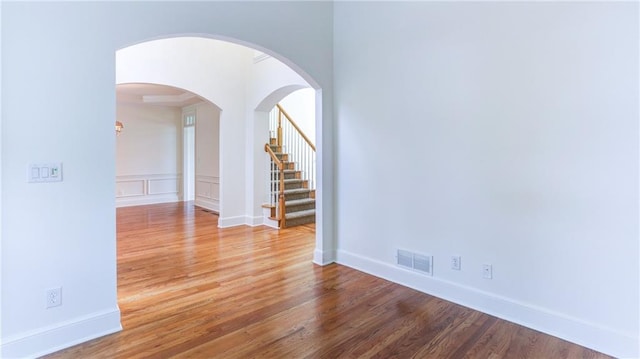 127 Grandmar Chase, Canton, GA 30115 - unfurnished room featuring wood finished floors, stairway, and arched walkways