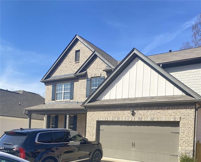 view of front of house with board and batten siding, brick siding, driveway, and an attached garage