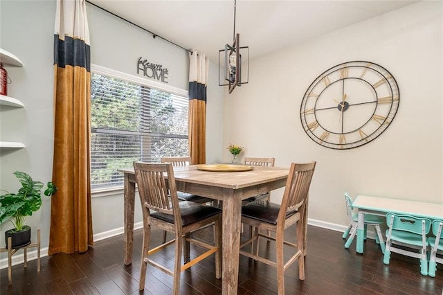 dining area with baseboards and wood finished floors