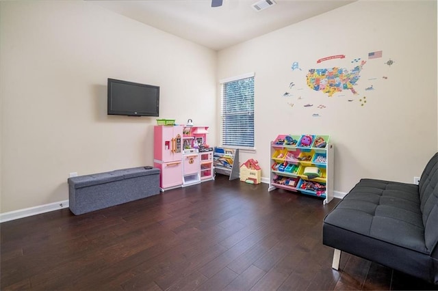 rec room featuring a ceiling fan, wood finished floors, visible vents, and baseboards