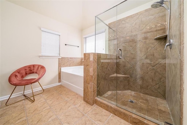 bathroom featuring tile patterned flooring, a garden tub, and a stall shower