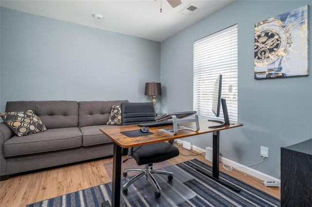 office area featuring ceiling fan, wood finished floors, visible vents, and baseboards