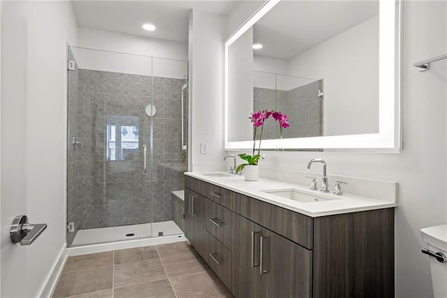 bathroom with toilet, tile patterned flooring, walk in shower, and vanity