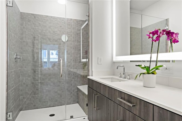 bathroom with an enclosed shower and vanity