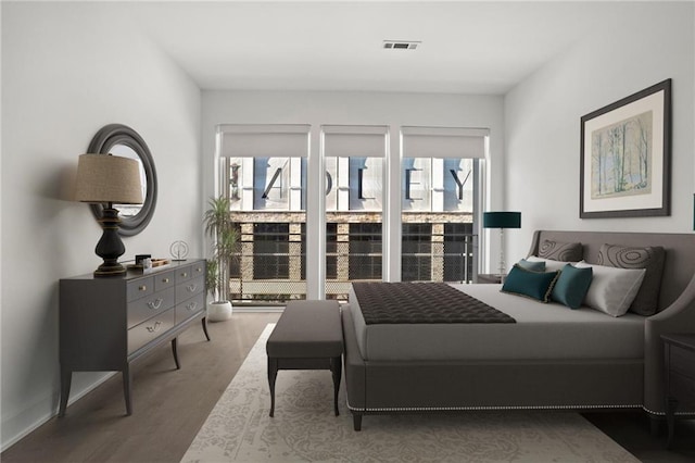 bedroom featuring light hardwood / wood-style floors and multiple windows