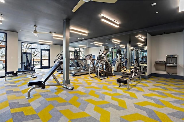 workout area with ceiling fan and carpet