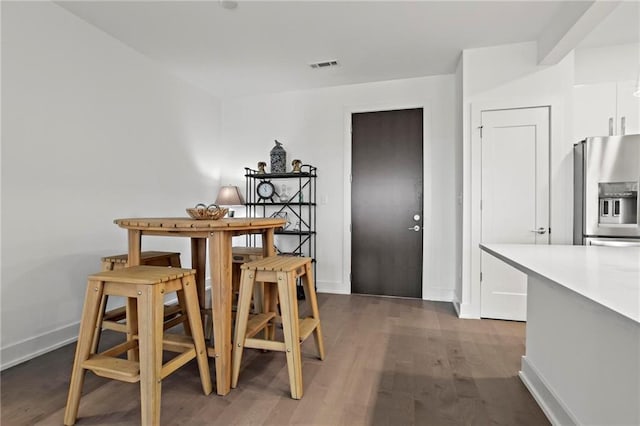 dining space featuring dark wood-type flooring