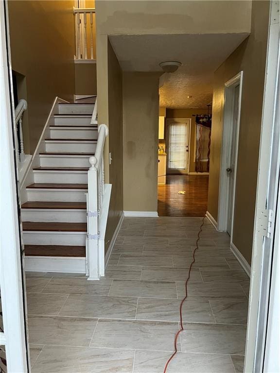 stairs featuring baseboards