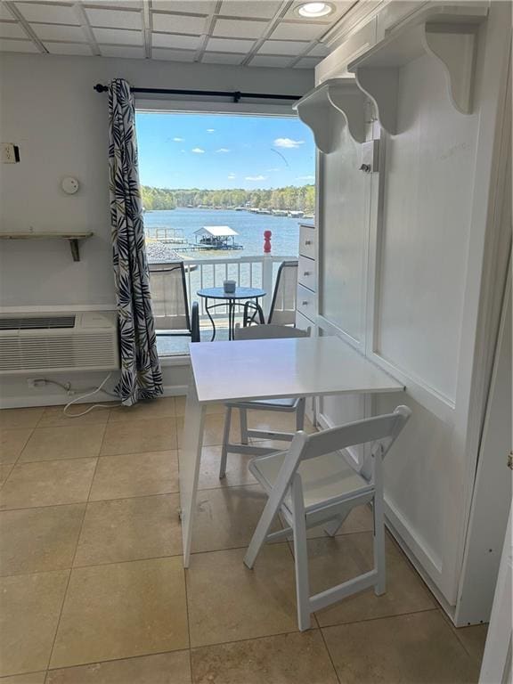 balcony featuring a water view and a wall mounted AC