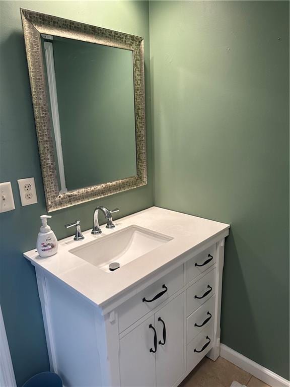 bathroom featuring tile patterned flooring, baseboards, and vanity