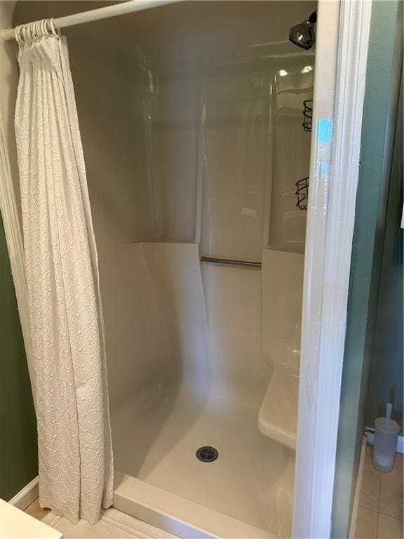 bathroom featuring a shower stall and tile patterned flooring