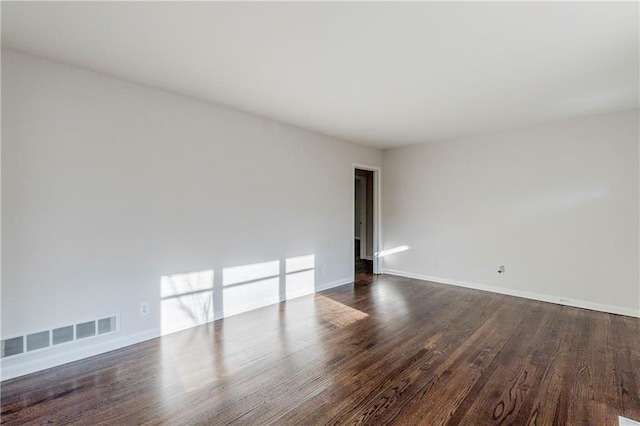 spare room with wood-type flooring