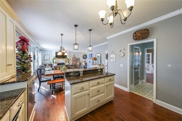 kitchen featuring cream cabinets, dark hardwood / wood-style floors, and ornamental molding