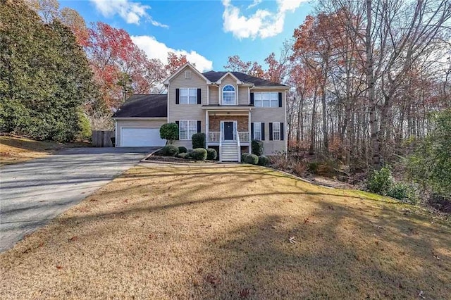 front facade with a front lawn and a garage