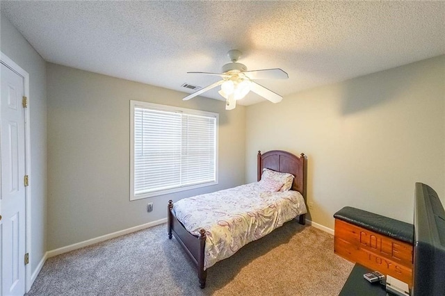 bedroom with carpet, a textured ceiling, and ceiling fan