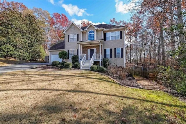 view of front property featuring a garage and a front lawn