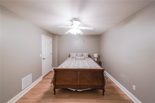 bedroom with light hardwood / wood-style floors and ceiling fan