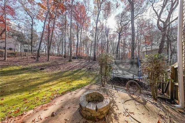 view of patio / terrace with an outdoor fire pit and a trampoline