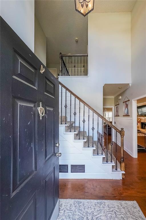 entryway featuring hardwood / wood-style floors and a high ceiling