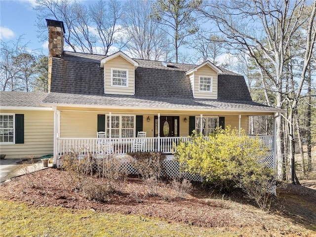 view of front of home with a porch and a shingled roof