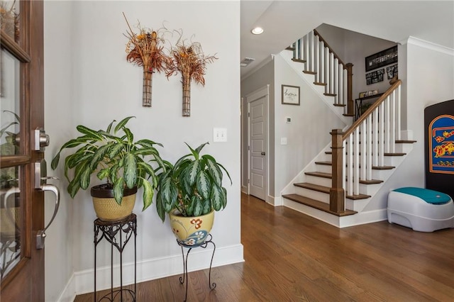 entryway featuring ornamental molding and dark wood-type flooring