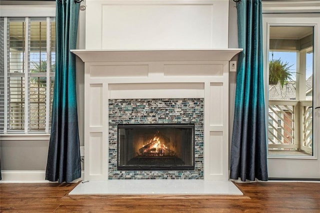 708 Mcgill Pl NE, Atlanta, GA 30312 - kitchen with stainless steel appliances, wall chimney range hood, white cabinets, a kitchen breakfast bar, and ornamental molding