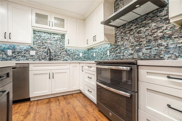 708 Mcgill Pl NE, Atlanta, GA 30312 - kitchen with wall chimney exhaust hood, stainless steel appliances, a sink, and light countertops