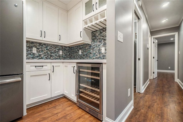 708 Mcgill Pl NE, Atlanta, GA 30312 - kitchen featuring freestanding refrigerator, beverage cooler, dark wood-type flooring, light countertops, and decorative backsplash