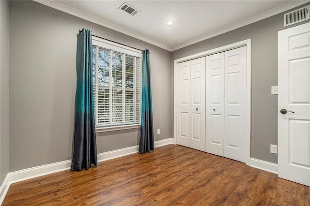 708 Mcgill Pl NE, Atlanta, GA 30312 - unfurnished bedroom featuring crown molding, wood finished floors, baseboards, a closet, and recessed lighting